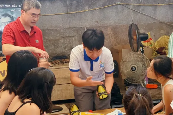 A craftsman making rubber tire sandals in Hanoi