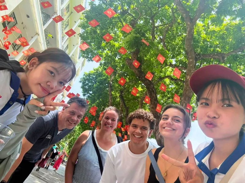 Early Hanoi Free Private Tour Guide members leading a walking tour in Hanoi Old Quarter