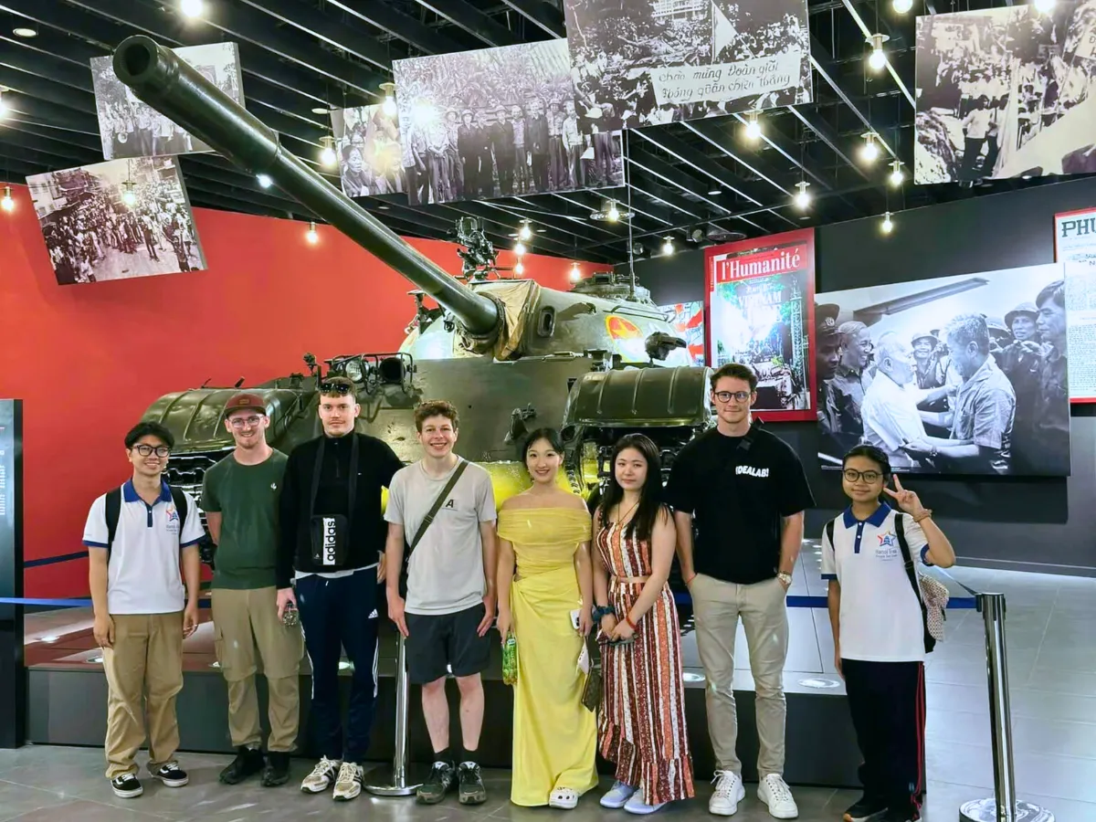 A local guide explaining a museum exhibit to visitors in Hanoi