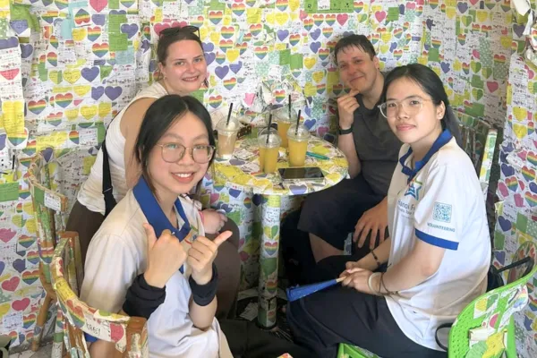 Travellers talking with Vietnamese students in Hanoi