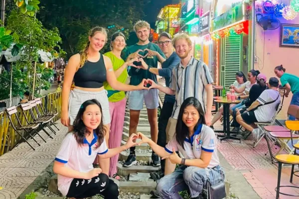 Travellers talking with Vietnamese students in Hanoi