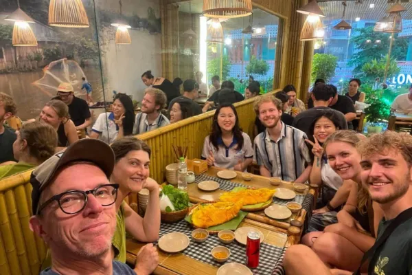 Guests eating street food with a local guide in Hanoi