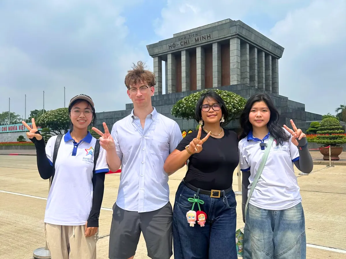 A young local guide leading a private Hanoi city tour at the Temple of Literature